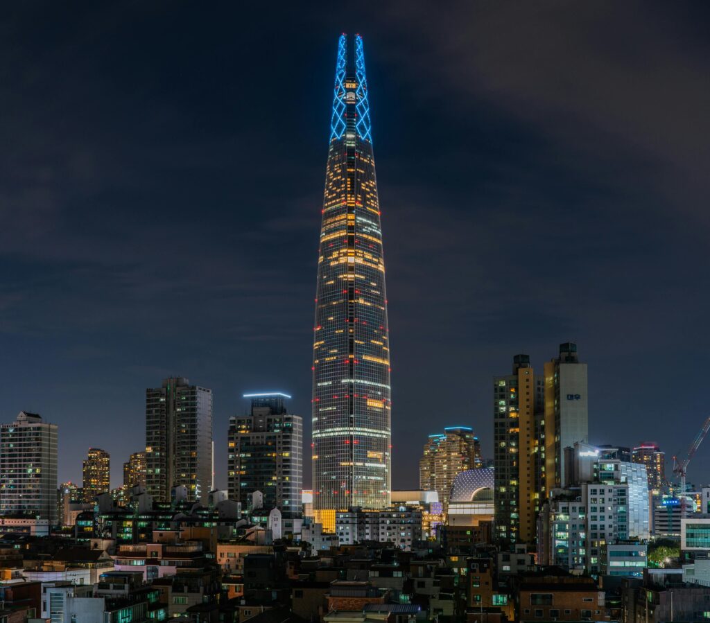 Stunning view of Lotte World Tower lighting up the Seoul skyline at night.